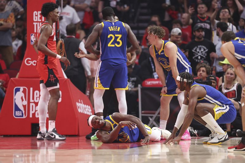 Apr 23, 2025; Houston, Texas, USA; Golden State Warriors forward Jimmy Butler III (10) suffers an apparent injury during the first quarter during game two of the first round for the 2024 NBA Playoffs against the Houston Rockets at Toyota Center. Mandatory Credit: Troy Taormina-Imagn Images