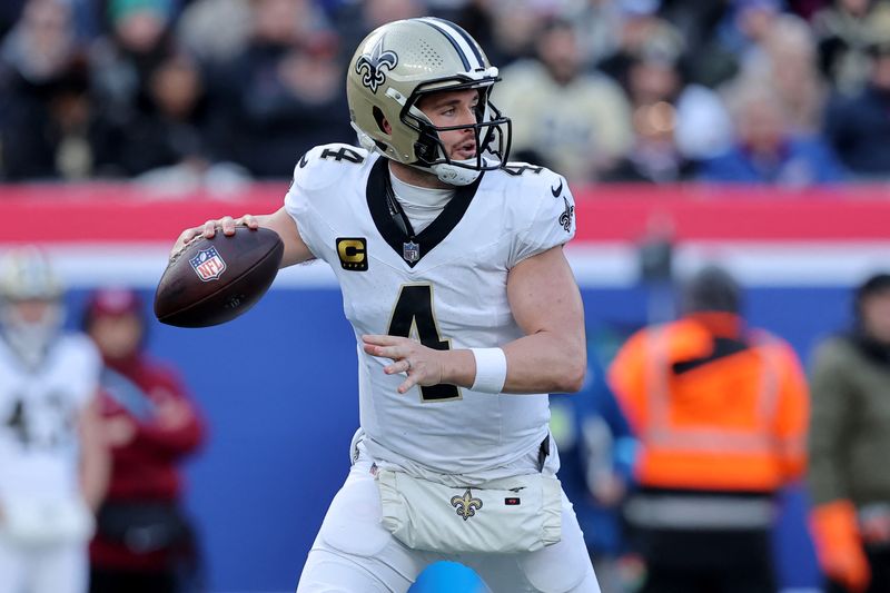 FILE PHOTO: Dec 8, 2024; East Rutherford, New Jersey, USA; New Orleans Saints quarterback Derek Carr (4) drops back to pass against the New York Giants during the first quarter at MetLife Stadium. Brad Penner-Imagn Images/ File Photo