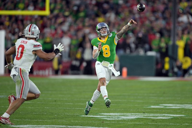 FILE PHOTO: Jan 1, 2025; Pasadena, CA, USA; Oregon Ducks quarterback Dillon Gabriel (8) passes against Ohio State Buckeyes linebacker Cody Simon (0) in the second half in the 2025 Rose Bowl college football quarterfinal game at Rose Bowl Stadium. Mandatory Credit: Jayne Kamin-Oncea-Imagn Images/File Photo