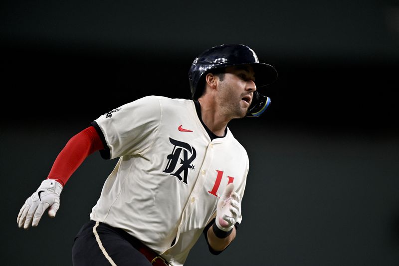 FILE PHOTO: Apr 4, 2025; Arlington, Texas, USA; Texas Rangers catcher Kyle Higashioka (11) scores on a single hit by Texas Rangers center fielder Leody Taveras (not pictured) during the third inning against the Tampa Bay Rays at Globe Life Field. Mandatory Credit: Jerome Miron-Imagn Images/File Photo