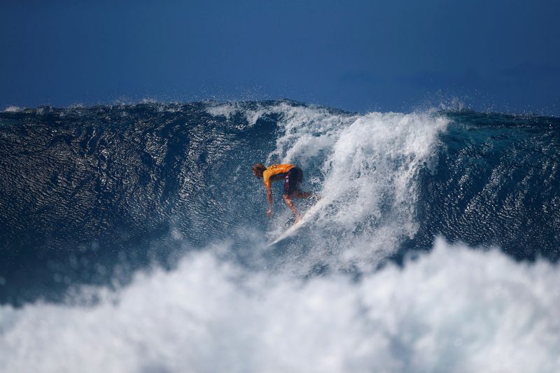 FILE PHOTO: Surfer John John Florence surfs during a heat at the Billabong Pipe Masters at the Banzai Pipeline in Pupukea on the island of Oahu, Hawaii, U.S. December 18, 2017. REUTERS/Eric Thayer/File Photo