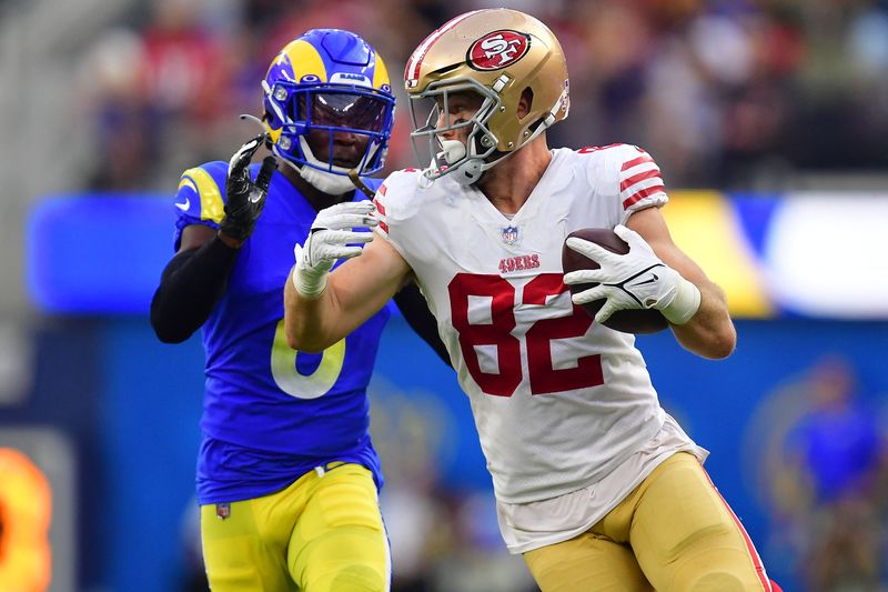 FILE PHOTO: Oct 30, 2022; Inglewood, California, USA; San Francisco 49ers tight end Ross Dwelley (82) runs the ball ahead of Los Angeles Rams cornerback Derion Kendrick (6) during the second half at SoFi Stadium. Mandatory Credit: Gary A. Vasquez-USA TODAY Sports/File Photo