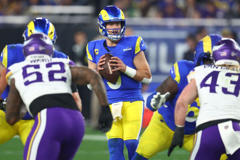 FILE PHOTO: Jan 13, 2025; Glendale, AZ, USA; Los Angeles Rams quarterback Matthew Stafford (9) drops back to pass against the Minnesota Vikings during the second half in an NFC wild card game at State Farm Stadium. Mandatory Credit: Mark J. Rebilas-Imagn Images/File Photo