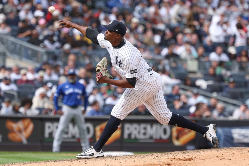 FILE PHOTO: Apr 27, 2025; Bronx, New York, USA; New York Yankees relief pitcher Yerry de los Santos (73) delivers a pitch during the seventh inning against the Toronto Blue Jays at Yankee Stadium. Mandatory Credit: Vincent Carchietta-Imagn Images/File Photo