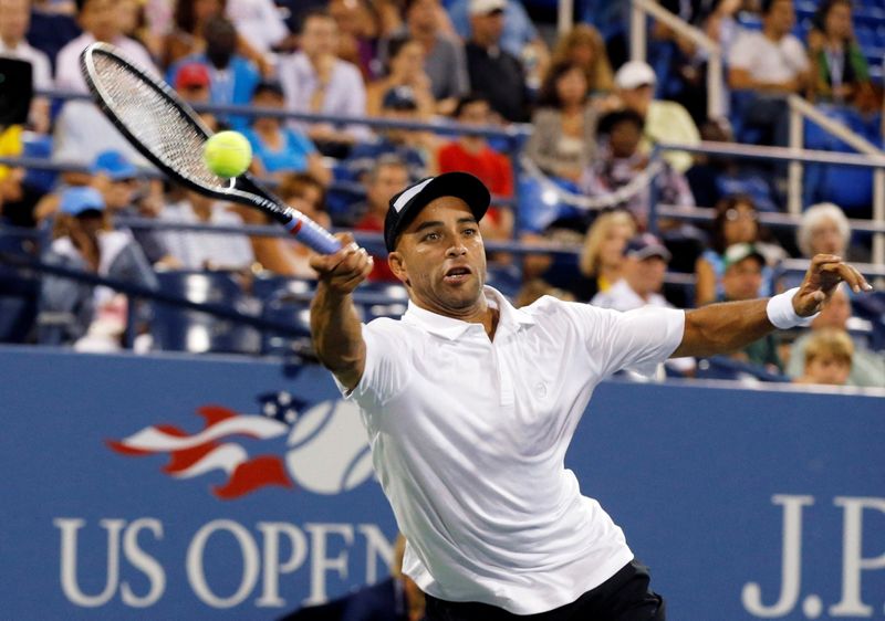 FILE PHOTO: James Blake of the U.S.  returns a forehand to Ivo Karlovic of Croatia at the U.S. Open tennis championships in New York, August 28, 2013. REUTERS/Ray Stubblebine/File Photo