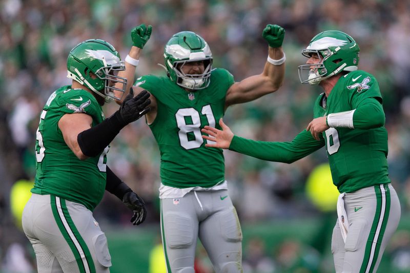 FILE PHOTO: Dec 29, 2024; Philadelphia, Pennsylvania, USA; Philadelphia Eagles quarterback Tanner McKee (16) celebrates with offensive tackle Lane Johnson (65) and tight end Grant Calcaterra (81) after his first NFL touchdown pass during the third quarter against the Dallas Cowboys at Lincoln Financial Field. Mandatory Credit: Bill Streicher-Imagn Images/File Photo