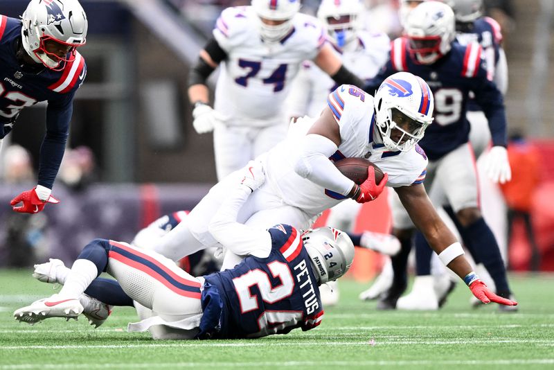 FILE PHOTO: Jan 5, 2025; Foxborough, Massachusetts, USA; Buffalo Bills tight end Quintin Morris (85) is tackled by New England Patriots safety Dell Pettus (24) during the first half at Gillette Stadium. Mandatory Credit: Brian Fluharty-Imagn Images/File Photo