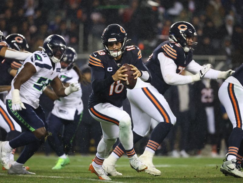 FILE PHOTO: Dec 26, 2024; Chicago, Illinois, USA; Chicago Bears quarterback Caleb Williams (18) rolls out of the pocket during the third quarter against the Seattle Seahawks at Soldier Field. Mandatory Credit: Talia Sprague-Imagn Images/File Photo