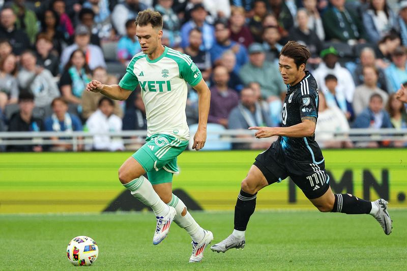 FILE PHOTO: Jun 22, 2024; Saint Paul, Minnesota, USA; Austin FC defender Leo Vaisanen (15) dribbles the ball against Minnesota United forward Sang Bin Jeong (11) during the first half at Allianz Field. Mandatory Credit: Matt Krohn-USA TODAY Sports/File Photo