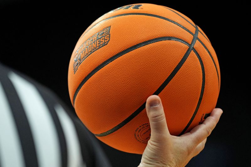 FILE PHOTO: Mar 22, 2025; Lexington, KY, USA; A referee holds the game ball during the second half of the game between the Tennessee Volunteers and the UCLA Bruins in the second round of the NCAA Tournament at Rupp Arena. Mandatory Credit: Aaron Doster-Imagn Images/File Photo