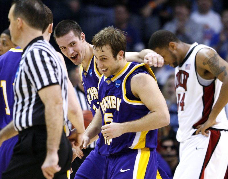 FILE PHOTO: Northern Iowa guard Ali Farokhmanesh (5) celebrates with teammates after his three-point shot which won the game against UNLV in their NCAA Division I Men's Basketball Tournament game in Oklahoma City, Oklahoma, March 18, 2010.  REUTERS/Bill Waugh/File Photo