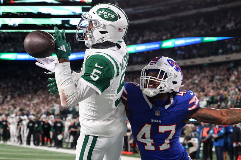 FILE PHOTO: Oct 14, 2024; East Rutherford, New Jersey, USA; Buffalo Bills cornerback Christian Benford (47) knocks the ball away from New York Jets wide receiver Garrett Wilson (5) during the second half at MetLife Stadium. Mandatory Credit: Ed Mulholland-Imagn Images/File Photo