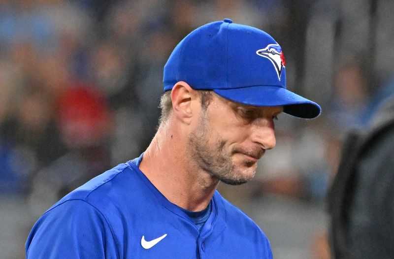 FILE PHOTO: Mar 29, 2025; Toronto, Ontario, CAN;  Toronto Blue Jays pitcher Max Scherzer (31) walks to the dugout after giving up two home run against the Baltimore Orioles in the first inning at Rogers Centre. Mandatory Credit: Dan Hamilton-Imagn Images/File Photo