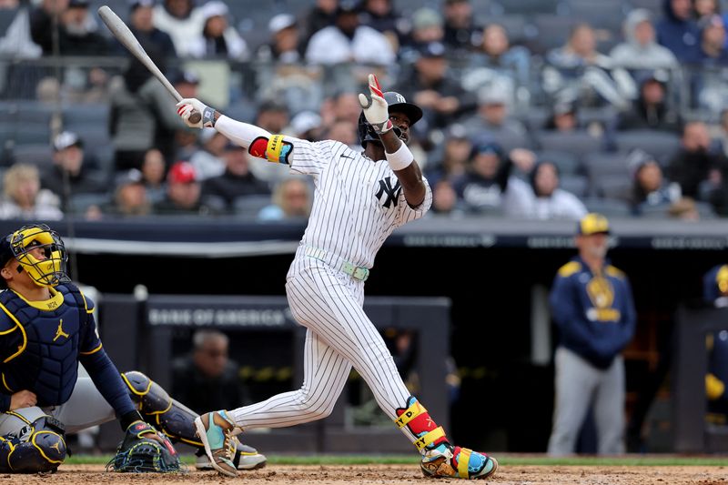 Mar 30, 2025; Bronx, New York, USA; New York Yankees second baseman Jazz Chisholm Jr. (13) follows through on a three run home run against the Milwaukee Brewers during the seventh inning at Yankee Stadium. Brad Penner-Imagn Images
