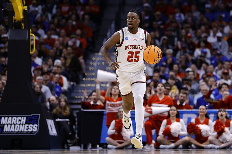 FILE PHOTO: Mar 22, 2025; Denver, CO, USA; Wisconsin Badgers guard John Blackwell (25) dribbles the ball against the Brigham Young Cougars during the first half in the second round of the NCAA Tournament  at Ball Arena. Mandatory Credit: Isaiah J. Downing-Imagn Images/File Photo