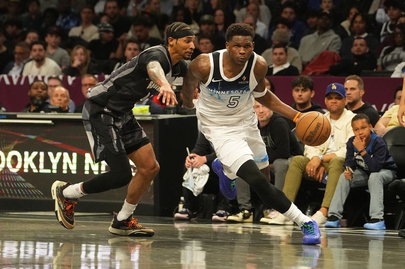 Apr 3, 2025; Brooklyn, New York, USA; Minnesota Timberwolves shooting guard Anthony Edwards (5) dribbles the ball past Brooklyn Nets guard Keon Johnson (45) during the second half at Barclays Center. Mandatory Credit: Gregory Fisher-Imagn Images