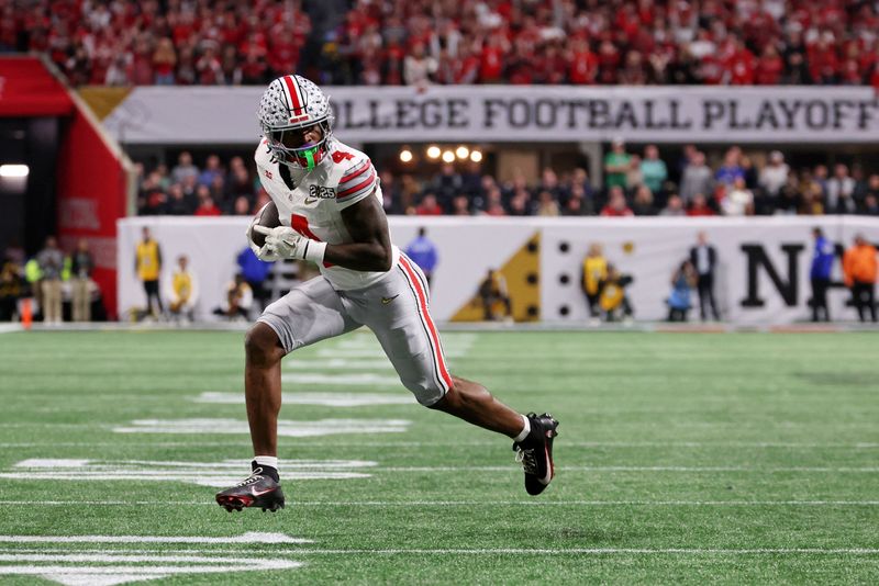 FILE PHOTO: Jan 20, 2025; Atlanta, GA, USA; Ohio State Buckeyes wide receiver Jeremiah Smith (4) runs with the ball for a touchdown during the first half the CFP National Championship college football game at Mercedes-Benz Stadium. Mandatory Credit: Brett Davis-Imagn Images