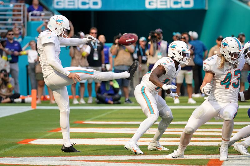 FILE PHOTO: Sep 25, 2022; Miami Gardens, Florida, USA; Miami Dolphins punter Thomas Morstead (4) punts the ball off of the backside of wide receiver Trent Sherfield (14) resulting in the ball going out of bounds and a safety for the Buffalo Bills during the second half at Hard Rock Stadium. Mandatory Credit: Jasen Vinlove-USA TODAY Sports/File Photo