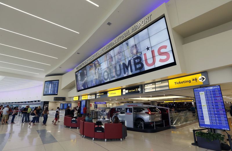 Visitors and travelers walk between the councourses inside John Glenn International Airport in Columbus on July 10, 2018. [Adam Cairns / Dispatch]