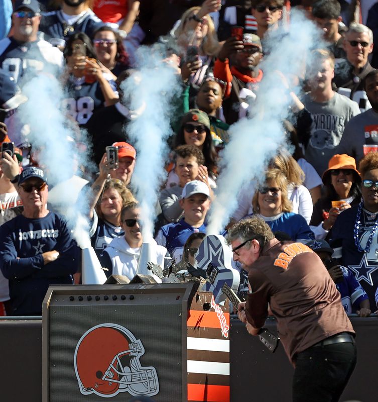 Akron native Patrick Carney of The Black Keys smashes a guitar before the start of the Cleveland Browns' season opener against the Dallas Cowboys at Huntington Bank Field, Sunday, Sept. 8, 2024, in Cleveland, Ohio.