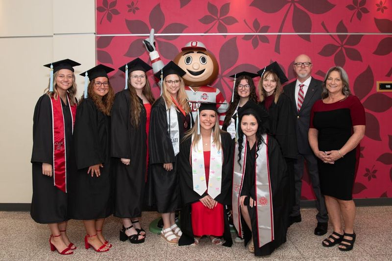 Brutus Buckeye celebrates with some of the graduates at Ohio State Mansfield.