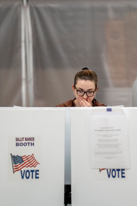 Alyssa Sharp, 24 of Victorian Village, casts her ballot, May 6, 2025; in Columbus. Ohio voters trickle in to cast ballots on statewide Issue 2 and some Franklin County voters find primary races and school issues.