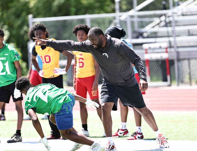 Aiken head coach Harry McCall gives instruction during the Southwest Ohio Small School Combine at Finneytown High School Wednesday, May 7, 2025.