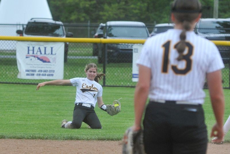 Colonel Crawford's Peyton Rowlinson slides to catch a ball in shallow right field.