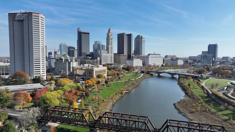 Downtown Columbus skyline with the Scioto River, American Electric Power headquarters and the Joseph P. Kinneary U.S. Courthouse along the Scioto Mile Park.
