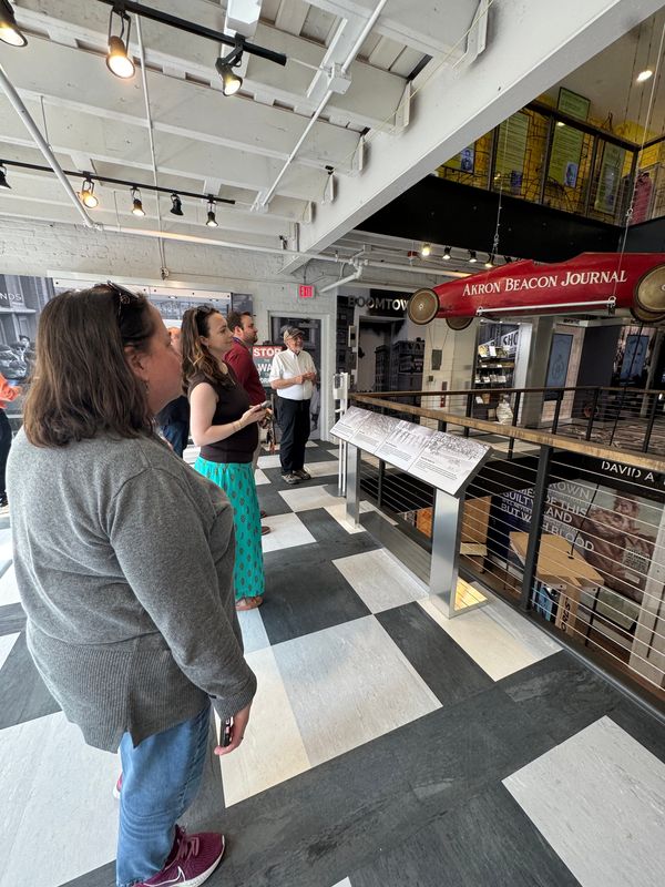 Akron Beacon Journal staff members, from left, Stephanie Warsmith, Theresa Bennett and Patrick Williams take note of a Beacon Journal-sponsored soap box derby car on display at the Akron History Center during a recent tour led by, far right, retired Beacon Journal reporter Bob Downing, a volunteer at the museum.