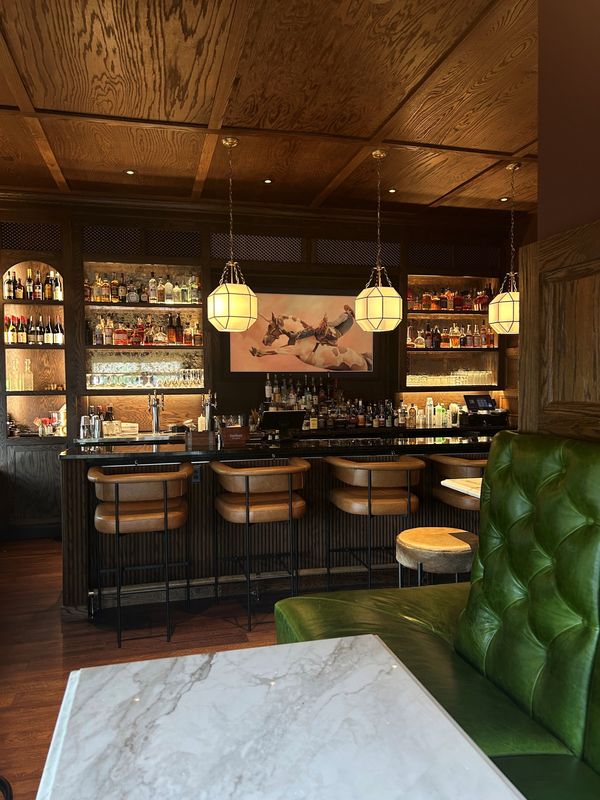 The Delmonico is designed to feel like an early 1900s railroad dining car.