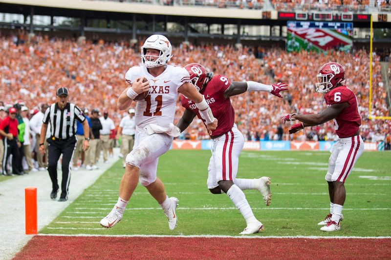 Texas quarterback Sam Ehlinger (11) smiles as he runs into the end zone for a score against Oklahoma at the Cotton Bowl in Dallas on Oct. 6, 2018.