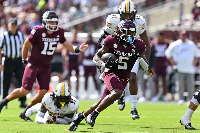 Oct 5, 2024; College Station, Texas, USA; Texas A&M Aggies running back Amari Daniels (5) runs the ball in the first quarter against the Missouri Tigers at Kyle Field. Mandatory Credit: Maria Lysaker-Imagn Images.