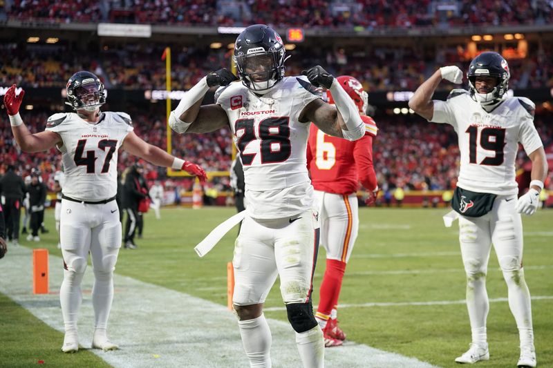 Jan 18, 2025; Kansas City, Missouri, USA; Houston Texans running back Joe Mixon (28) celebrates with fullback Andrew Beck (47) and wide receiver Xavier Hutchinson (19) after scoring a touchdown against the Kansas City Chiefs during the third quarter of a 2025 AFC divisional round game at GEHA Field at Arrowhead Stadium. Mandatory Credit: Denny Medley-Imagn Images
