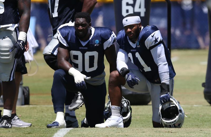 Jul 30, 2024; Oxnard, CA, USA; Dallas Cowboys defensive end DeMarcus Lawrence (90) and linebacker Micah Parsons (11) during training camp at the River Ridge Playing Fields in Oxnard, California. Mandatory Credit: Jason Parkhurst-USA TODAY Sports