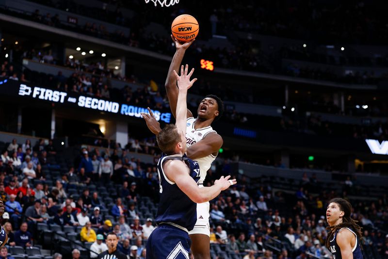 Texas A&M Aggies forward Pharrel Payne (21) shoots over Yale Bulldogs forward Nick Townsend (42) during the first half March 20, 2025 at Ball Arena in Denver.