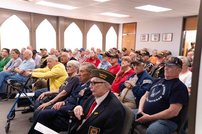 Veterans and families listen intently Saturday at a National Vietnam Veterans anniversary service at the Texas Panhandle War Memorial Center in Amarillo.