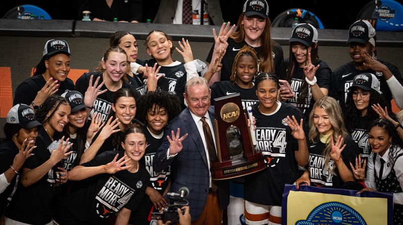 Texas Longhorns head coach Vic Schaefer and his team celebrate after the Longhorns' 58-47 win over the TCU Horned Frogs in the NCAA Playoff Regional final game against at Legacy Arena in Birmingham Alabama, March 31, 2025. The Longhorns will face South Carolina in the Final Four.