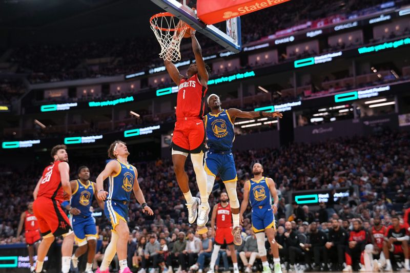 Apr 6, 2025; San Francisco, California, USA; Houston Rockets forward Amen Thompson (1) makes a basket in front of Golden State Warriors forward Jimmy Butler III (10) in the third quarter at the Chase Center. Mandatory Credit: Cary Edmondson-Imagn Images
