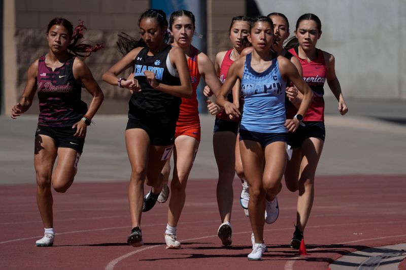 Rebecca Duran, of Chapin High School, leads the pack at the start of the 3,200 meters to win in the Class 5A area meet at the SAC 1 on April 11, 2025.