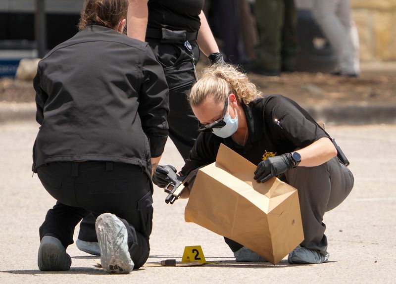 Crime scene investigators with the Travis County sheriff’s office collect a gun for evidence after a deputy-involved shooting Friday in the parking lot of a Randalls grocery store on RM 620 North near the Steiner Ranch area.