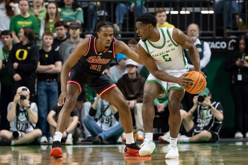 Oregon guard TJ Bamba, right, looks for room to move under cover from Indiana forward Mackenzie Mgbako as the Oregon Ducks host the Indiana Hoosiers Tuesday, March 4, 2025, at Matthew Knight Arena in Eugene, Ore.