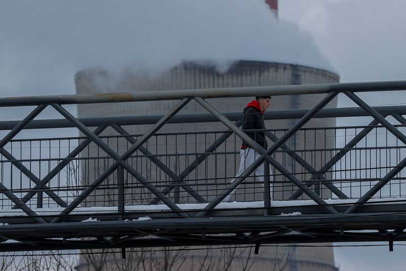 A man walks near the coal-fired power plant, in Obilic