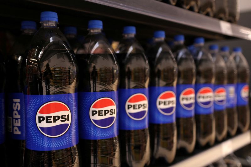 Bottles of Pepsi are displayed on a shelf in supermarket