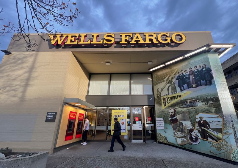 A man walks from a branch of Wells Fargo bank in the University District of Seattle