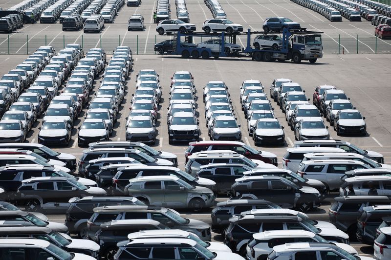 FILE PHOTO: A car carrier transporting vehicles made by Kia Motors, which is part of South Korea's biggest automaker company Hyundai Motor, arrives at Pyeongtaek port in Pyeongtaek, South Korea, April 15, 2025.   REUTERS/Kim Hong-Ji/File Photo