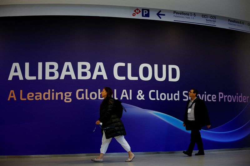 FILE PHOTO: People walk past an Alibaba Cloud sign during the 2025 Mobile World Congress (MWC) in Barcelona, Spain, March 3, 2025. REUTERS/Albert Gea/File photo