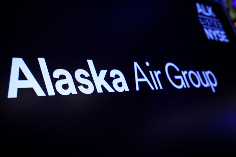 A screen displays the logo of Alaska Air Group on the floor at the New York Stock Exchange (NYSE) in New York City, U.S., December 4, 2023.  REUTERS/Brendan McDermid