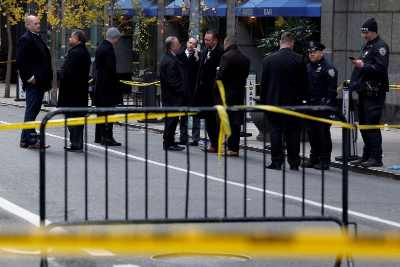 FILE PHOTO: Law enforcement officers stand near the scene where the CEO of UnitedHealthcare Brian Thompson was reportedly shot and killed in Midtown Manhattan, in New York City, US, December 4, 2024.REUTERS/Shannon Stapleton/File Photo