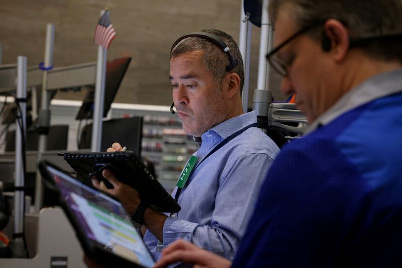 FILE PHOTO: A futures-options trader works on the floor at the American Stock Exchange (AMEX) at the New York Stock Exchange (NYSE) in New York City, U.S., April 24, 2025.  REUTERS/Brendan McDermid/File Photo